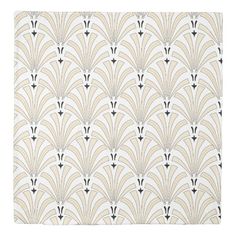 an art deco style tile with gold and white designs on the back, along with black accents