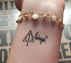 a woman's arm with a tattoo on it that says always and an arrow