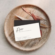 a business card sitting on top of a wooden plate