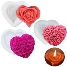 three heart shaped candles with roses in the middle and one lit candle on each side