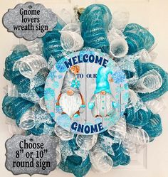 a welcome to our gnome door hanger with blue and silver decorations on it's side