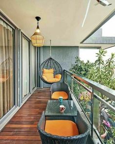 an outdoor balcony with wicker furniture and orange cushions