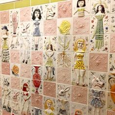 a tiled wall covered in many different types of ceramic figurines on it's sides