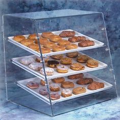 three tiered display case with donuts and other pastries on it's sides