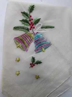 Vintage Handkerchief Christmas Holiday--pretty embroidered bells in purple, gold and blue. Scattered holly berries and leaves and little gold stars add interest. Original paper tag still attached--Desco All Cotton Made in Switzerland. Original folds in triangle shape Size: 12 1/2" square Condition: very good vintage--unused.  Note there is slight yellowing at the corners from storage. Also note we had a heck of a time trying to re-fold in triangle shape. Price:$8 #9234b This will be shipped in bubble envelope as folded Holly Leaves And Berries, Vintage Handkerchief, Embroidered Christmas, Holly Leaves, Vintage Handkerchiefs, Holly Berries, Holly Leaf, Bubble Envelopes, Paper Tags