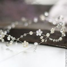 the tiara is adorned with pearls and beads