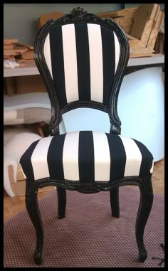 a black and white striped chair sitting on top of a rug