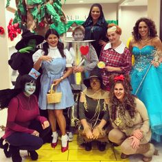 a group of women dressed in costumes posing for a photo