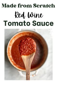 a wooden spoon with tomato sauce in it and the words made from scratch red wine tomato sauce