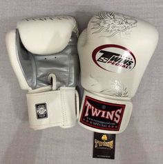 the twins boxing gloves are white and silver