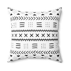 a black and white pillow with arrows on it