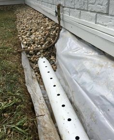 a pile of rocks sitting on top of a white plastic sheet next to a building