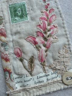 a close up of a piece of cloth with flowers on it and a button in the middle