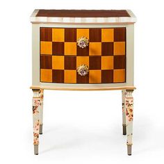 a wooden chest with two drawers on one side and a checkerboard design on the other