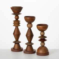 three wooden candlesticks sitting next to each other