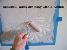 a person using a roller to paint a wall with decorative stencils and text that reads, beautiful walls are easy with a roller