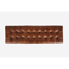 a brown leather couch with buttons on the back and arms, in front of a white background