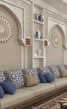 a living room filled with lots of furniture next to a wall covered in bookshelves