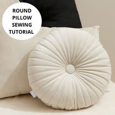 a round pillow sitting on top of a bed next to two pillows with the words round pillow sewing pattern