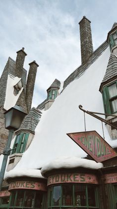 an old fashioned building with snow on the roof