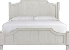 a white bed with wooden headboard and foot board, made from wood planks