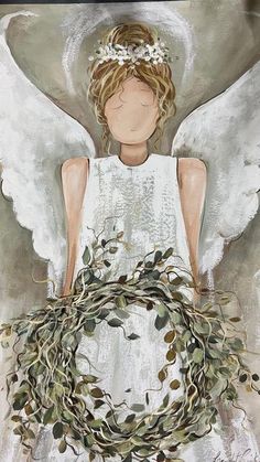 an angel with white wings holding a wreath