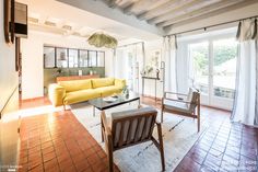 a living room with yellow couches and chairs in it's centerpieces