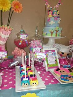 a table topped with lots of cake and candy