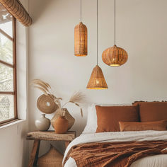 a bedroom with three hanging lights above the bed and two planters on the side table