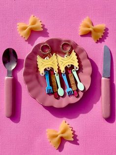 a pink plate topped with different types of utensils