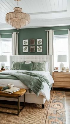 a bedroom with green walls and white bedding