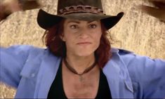 a woman wearing a cowboy hat and blue shirt