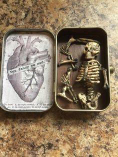 two tins that have skeletons in them