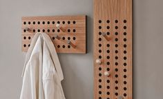 a coat rack and coat hanger on the wall