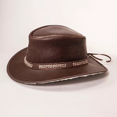 The American outback-style Bison Mens Leather Hat is made of an extremely soft, almost buttery bison leather. It offers ultimate sun and rain protection while being one of the softest, most comfortable hats you'll ever wear. Featuring a super comfortable removable sweatband liner that attaches securely with velcro tabs sewn-in to the hat. Easily swap the liner for a half or full-size reducing sweatband (included with purchase) to achieve the perfect fit. Rugged Brown Hunting Hat, Rustic Brown Hunting Hat, Adjustable Brown Rugged Hat, Adjustable Rugged Brown Hat, Leather Hats For Ranch In Winter, Winter Leather Ranch Hats, Outdoor Flat Brim Hat With Leather Sweatband, Outdoor Leather Hat Bands With Sweatband, Leather Hats For Hunting With Flat Brim