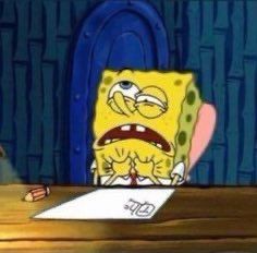 spongebob sitting at a table with a pen and paper in front of him