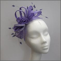 Pretty light purple sinamay fascinator with rose swirl effect centre. Diamanté covered loops and fine cut feathers finish the look. Made on a headband.  Ideal floral headpiece for a wedding, race day / ladies day, special occasion or formal event. Designs can be made to order in a range of different colours or styles, see our colour chart: www.jacquivaledesigns.com/colour_chart.html Please contact me if you would like a design in a different colour. We can make a range of ladies hats, fascinator Luxury Elegant Lavender Fascinator, Luxury Purple Summer Fascinator, Purple Headband With Handmade Flowers, Purple Handmade Flowers Headband, Purple Fascinator With Handmade Flowers For Parties, Purple Handmade Flowers Fascinator For Party, Purple Party Fascinator With Handmade Flowers, Purple Headpiece With Handmade Flowers For Kentucky Derby, Purple Handmade Flowers Headpiece For Kentucky Derby