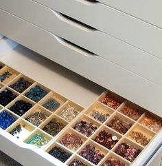 the drawers are filled with beads and other items