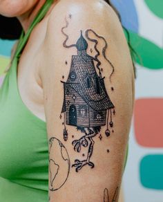 a woman with a house tattoo on her arm