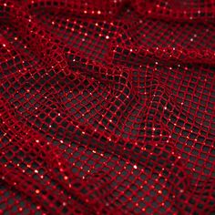 red sequins on black mesh fabric