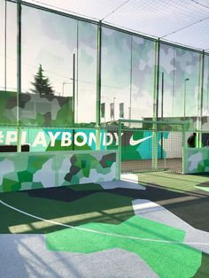 a tennis court with the words playbond painted on it's side wall