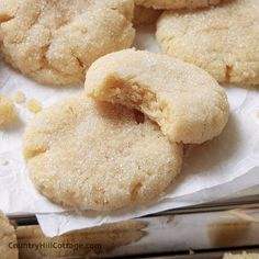 some sugary cookies are sitting on a piece of wax paper