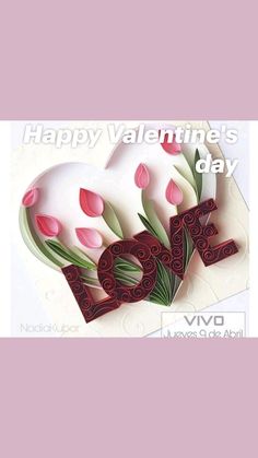 a card with the word love made out of paper and tulips on it