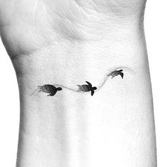 three birds flying in the sky on a wrist