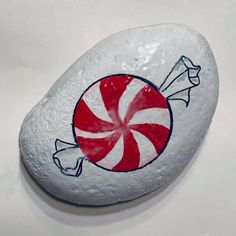 a rock with a candy cane painted on it