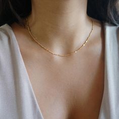 Gold Dainty Sparkle Chain Delicate Thread Chain Minimalist Layering Choker Tiny Chain Necklace Jewelry Gift for Women The perfect add-on to any wardrobe. Shiny and dainty, for either a casual or more elegant style. Great to combine with other pieces from our shop for a layered look. Delicate chain gold plated / rhodium plated over stainless steel. Very thin and delicate 1.5mm, with flattened beads sparkling like little mirrors. Sturdy and high quality. Minimalist Necklace Layering, Decent Gold Jewellery, Minimalist Chain Necklace, Small Gold Chain For Women, Good Chains Women, Small Dainty Jewelry, Modern Gold Chain Designs For Women, Simple Chains For Daily Use, Dainty Gold Choker