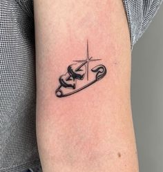 a tattoo on the arm of a person with a car and arrow in the middle