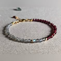 P R O D U C T D E T A I L S - This Dainty Bracelet Features Half Misterious Labradorite And Half Intense Deep Red Garnet Accompanied With 14 Karat Gold Filled Beads And Other 14 Karat Gold Filled Settings. The Beads Are About 3.5 Mm, A Very Light And Elegant Bracelet. - Bracelet Size Is 7” Inches Plus 1” Inch Extender Chain. (Custom Length Is Available). - This Bracelet Is Also Made To Order In Sterling Silver. - Minimalist Design, Handcrafted By Us In Pennsylvania , Usa. - Garnet Is The Officia Gemstone Beaded Bracelets Lovepray Jewelry, Gray Beaded Bracelet, Red Garnet Bracelet, Elegant Beads Bracelet, Garnet Chip Jewelry, Gemstone Bracelet Ideas, Gemstone Bracelets Ideas, Gem Bracelets, Stone Bead Bracelets