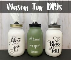 three mason jars with the words mason jar diys written on them and one has tissue in it