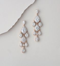 "Beautiful cascading waterfall teardrop earrings are a perfect accessory for bride or bridesmaid. Created with Swarovski Pure Brilliance stones in 3 different finishes. Available in rhodium, rose gold and yellow gold Earrings measure 2-1/2\" x 7/8\" Matching pieces: https://www.etsy.com/listing/674474135/rose-gold-bridal-bracelet-teardrop?ref=shop_home_active_1&pro=1&frs=1 https://www.etsy.com/listing/273104988/rose-gold-necklace-bridal-necklace?ref=shop_home_active_33 https://www.etsy.c Elegant Rose Gold Dangle Chandelier Earrings, Glamorous Drop Chandelier Earrings For Anniversary, Glamorous White Drop Chandelier Earrings, Glamorous Rose Gold Dangle Bridal Earrings, Glamorous Drop Chandelier Earrings For Wedding, Glamorous Wedding Drop Chandelier Earrings, Glamorous Rose Gold Dangle Chandelier Earrings, Rose Gold Dangle Chandelier Earrings For Formal Events, Rose Gold Dangle Teardrop Earrings